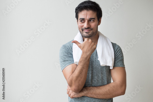 confident fitness man pointing thumb up gesture; portrait of happy, healthy, confident indian man training, working out in fitness gym; asian north indian adult man model