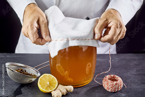 Man closing jar with kombucha tea photo