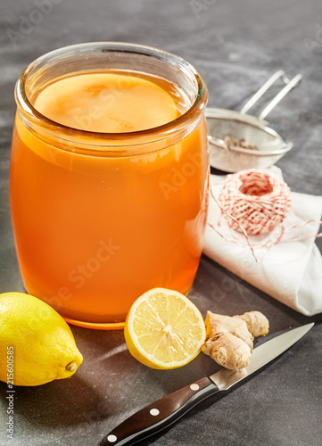 Glass jar of ready kombucha with scoby photo