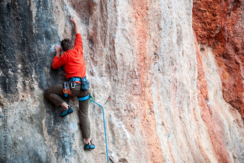 A man climbs the rock.