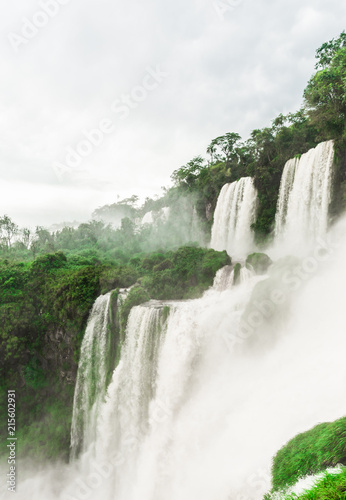 Wide angle landscape view of Iguazu falls waterfalls on a sunny day in summer. Photo taken from the Argentinian side.