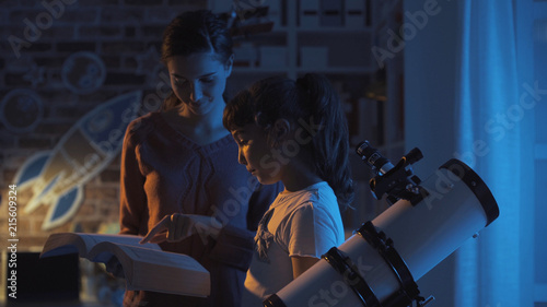 Obraz na plátně Sisters watching the stars and studying astromony