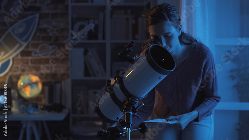 Woman stargazing with a professional telescope
