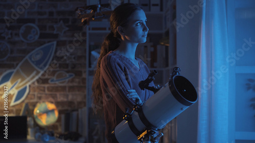 Woman stargazing with a professional telescope