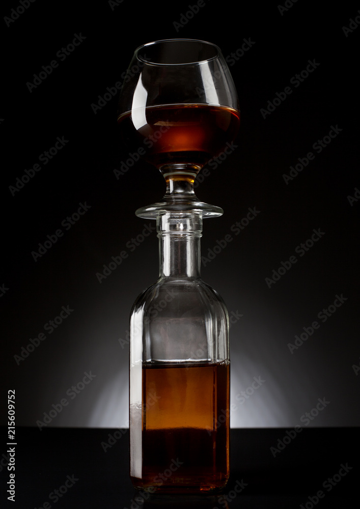 cognac glass on a bottle on dark bg studio shot cognac glass on a bottle on dark bg studio shot