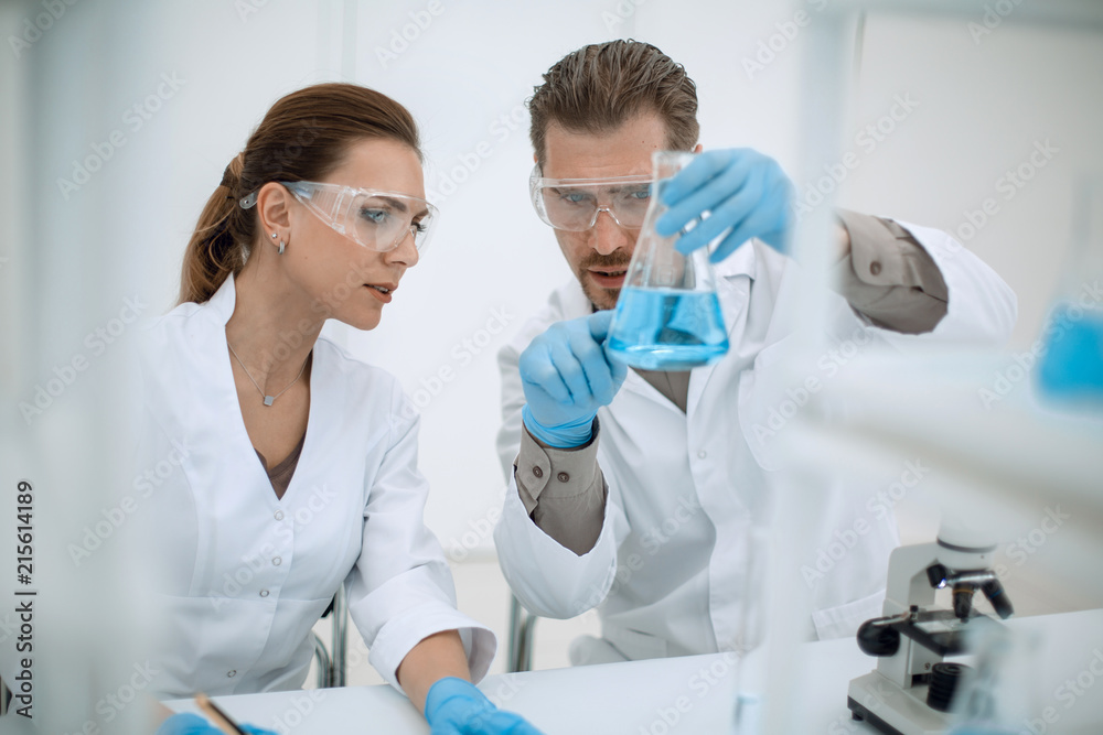 close up.two scientists discuss the results of testing. close up.two scientists discuss the results of testing.