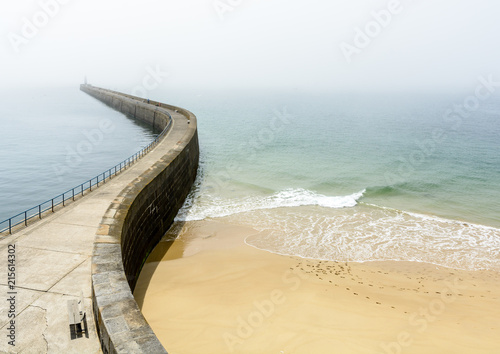 Konstfotografi The Mole des Noires, the long breakwater of the walled city of Saint-Malo in Brittany, France, and the Mole beach by a sunny and misty weather