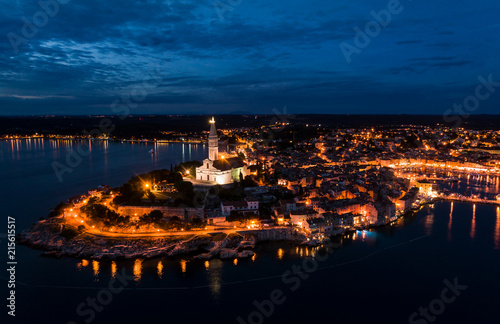 Beautiful Rovinj night aerial view taken by a professional drone from above the sea. Lights of the old town of Rovinj, Istria, Croatia