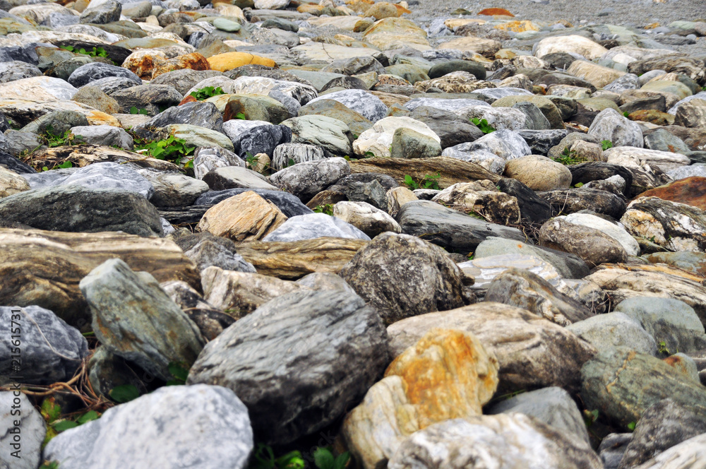 Nice scenery at Taiwan seaside with big rocks and pebbles, cloudy blue sky Nice scenery at Taiwan seaside with big rocks and pebbles, cloudy blue sky