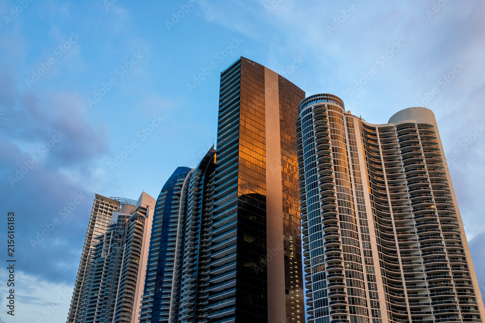 Sunny Isles Beach, USA cityscape skyline of apartment condo hotel buildings during night evening sunset blue hour in Miami, Florida with skyscrapers