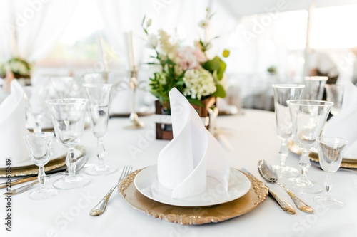 Table setting on a white tablecloth in the restaurant close-up
