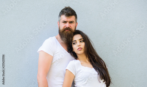 Couple friends hang out together. Youth stylish outfit simple but modern. Young and stylish. Couple white shirts cuddle near grey wall. Hipster bearded brutal and stylish fashionable girl hang out