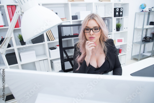Beautiful girl with glasses working at the computer