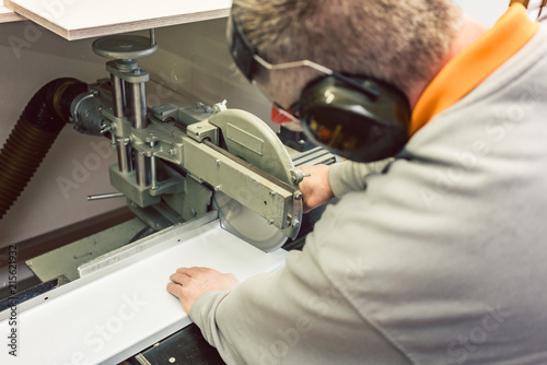 Foto Tinner cutting metal sheets in his workshop with saw, close-up