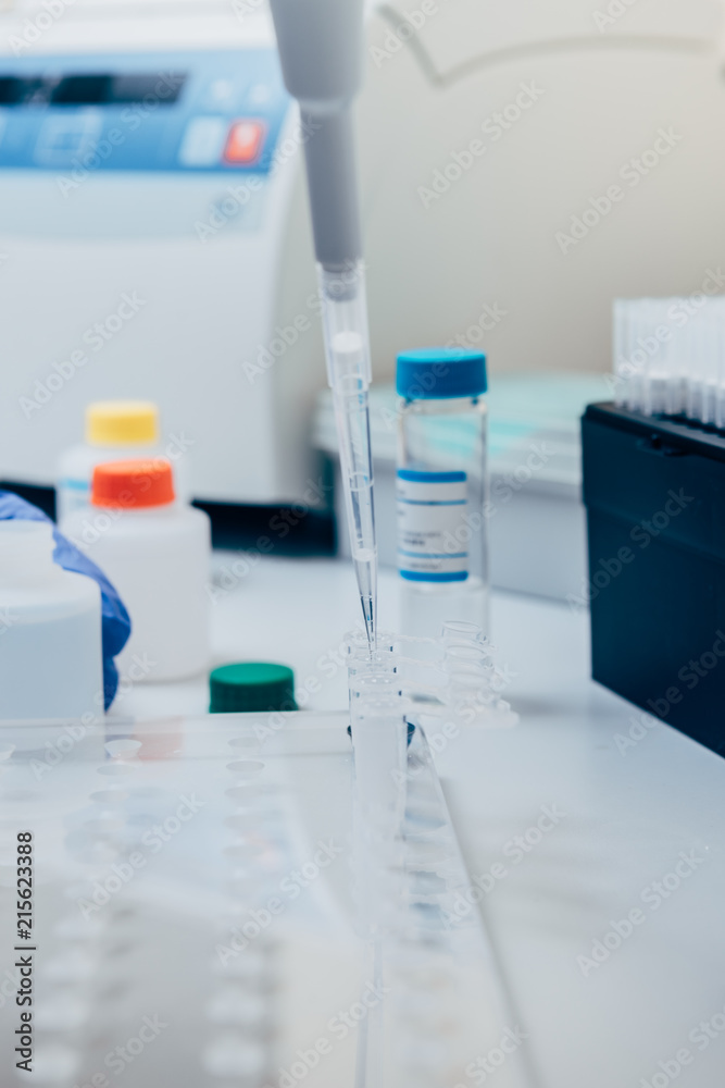 selective focus of pipette in modern biotechnology laboratory