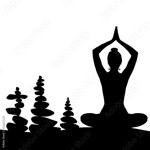 Silhouette of woman in yoga posture and balanced stones
