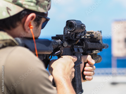 Man shooting rifle,shell ejecting