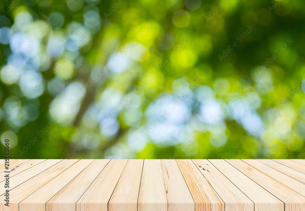 wood plank with abstract natural green blurred bokeh background for product display wood plank with abstract natural green blurred bokeh background for product display