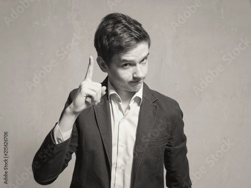 Studio portrait of a teenager boy.Emotions of a person, to attract attention.