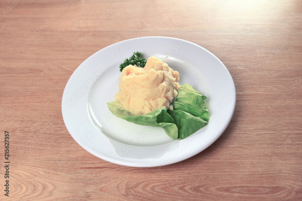 mashed potatoes with salad on white plate on wooden background mashed potatoes with salad on white plate on wooden background