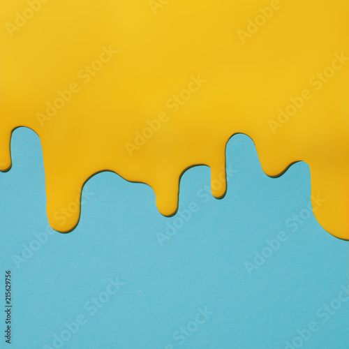 yellow paint texture on blue canvas. Minimalistic background with copy space. Creative concept.