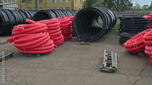 Fototapeta Naklejka Na Ścianę i Meble -  Warehouse of finished plastic pipes industrial outdoors storage site. Manufacture of plastic water pipes factory. Process of making plastic tubes on the machine tool with the use of water and air