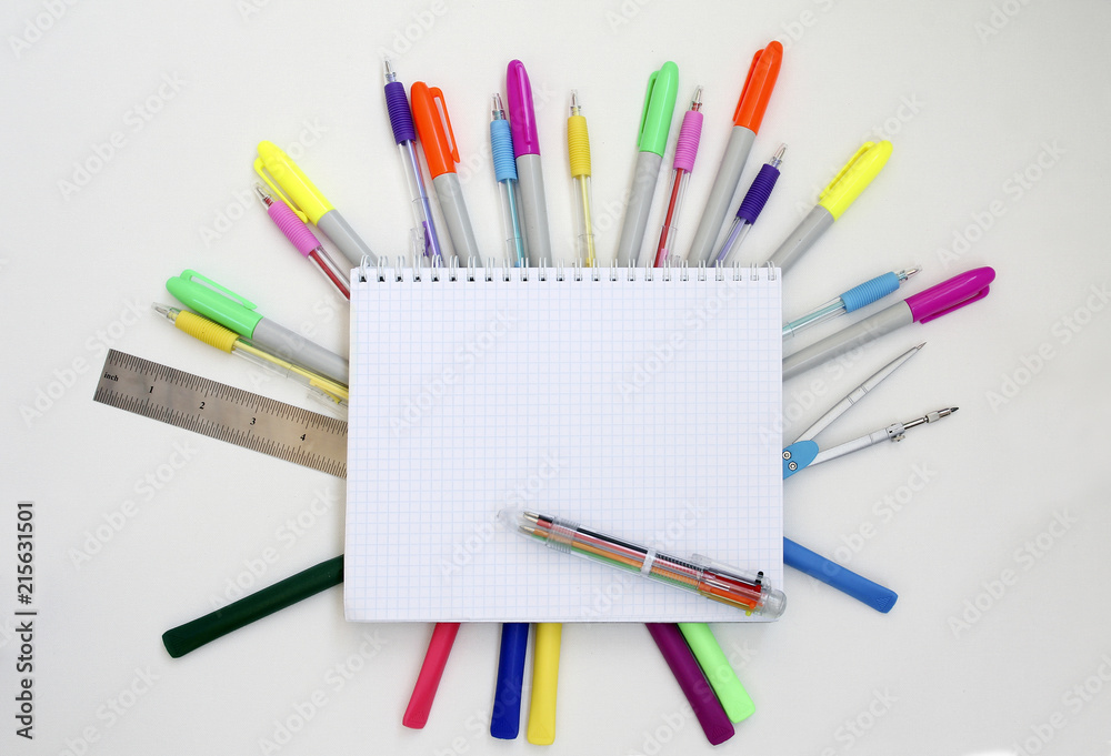Back to school concept. School education background with blank exercise book with copy space and colored pens and markers. Top view. Back to school concept. School education background with blank exercise book with copy space and colored pens and markers. Top view.