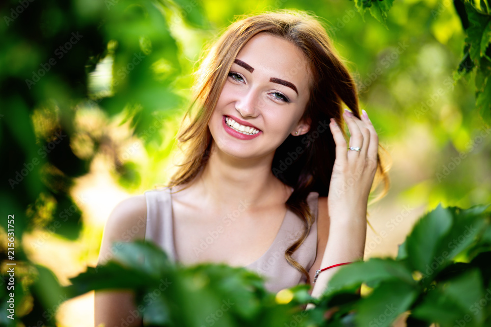 portrait of a beautiful girl in a summer garden, young woman in green foliage portrait of a beautiful girl in a summer garden, young woman in green foliage