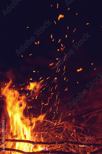 Night bonfire with sparks. Branches on fire © smartape