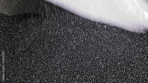 Fotografie Plastic black gray granulated crumb