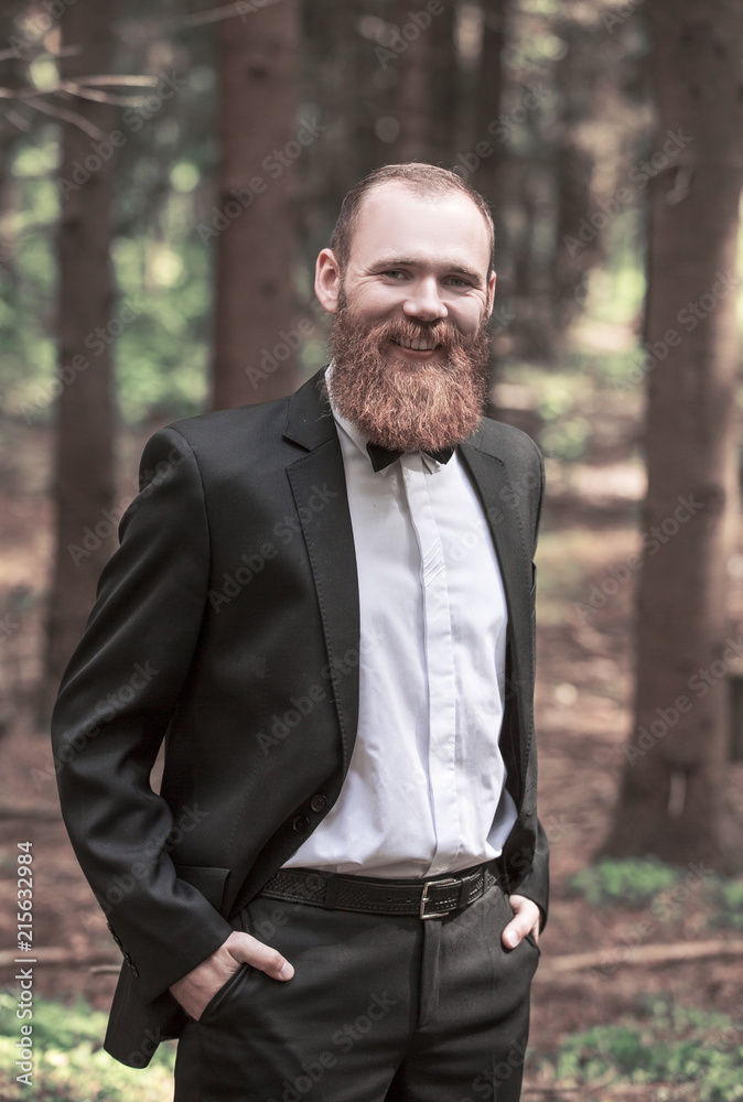 portrait of a successful man in a business suit on the background of the Park