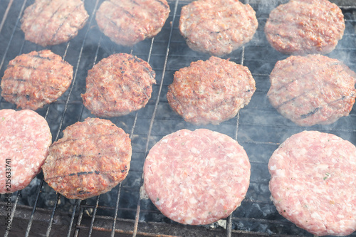 Fresh meat patties for burgers on the grill