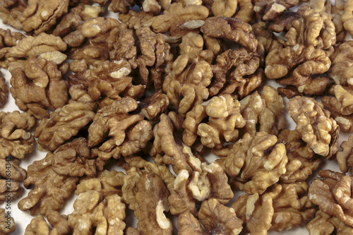Walnut kernels as concept of vegan food. On white background.