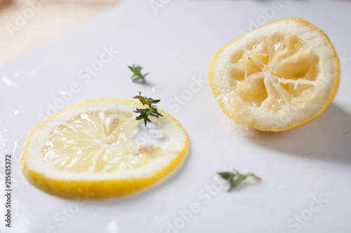 Slice of lemon and squeezed lemon on white background