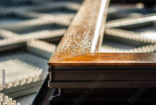 Detail of a PVC window profile margin, color wood in factory, shallow depth of field