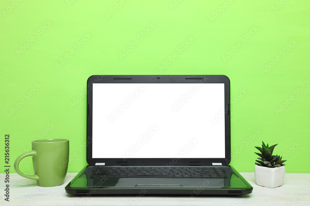 Laptop, a cup of tea and cactus Laptop, a cup of tea and cactus