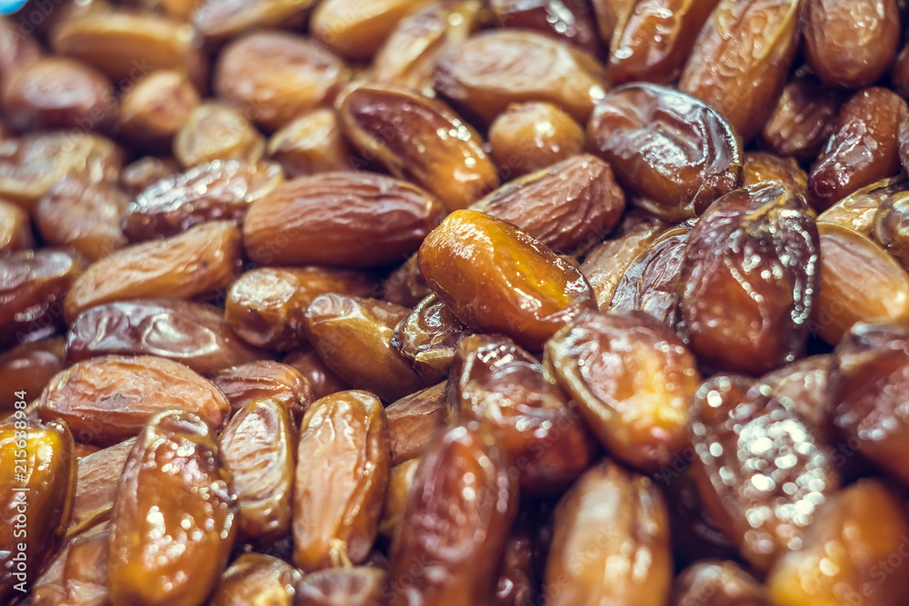 Golden shiny dates close-up. Eastern sweetness. Healthy eating. Assortment in the market Golden shiny dates close-up. Eastern sweetness. Healthy eating. Assortment in the market