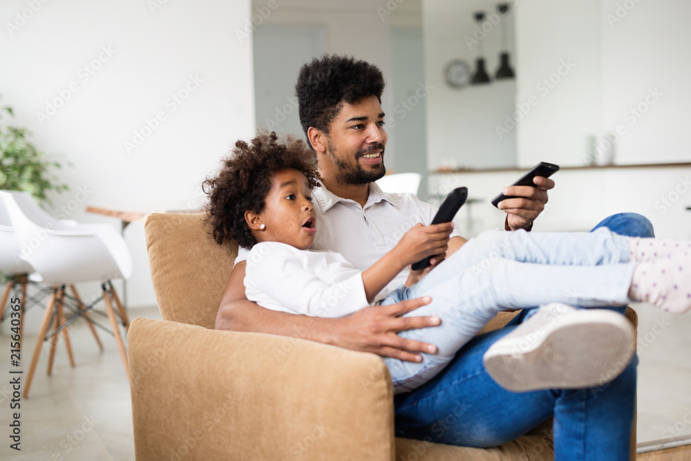 Father and daughter sitting on couch at home Father and daughter sitting on couch at home