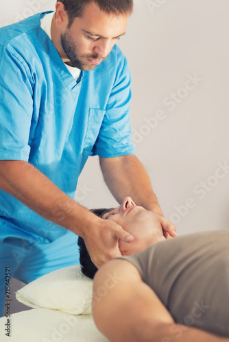 Physiotherapist Working With Patient Neck