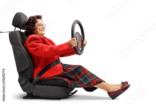 Mature woman seated in a car seat driving