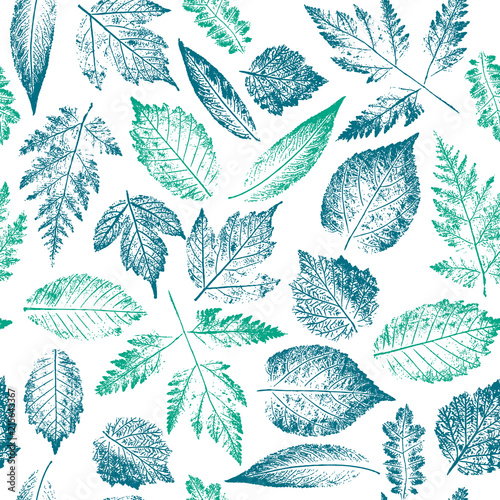 Abstract botanical pattern. Seamless print composed of blue and green stamps of leaves of tree and bush on white background. Bright colorful background.