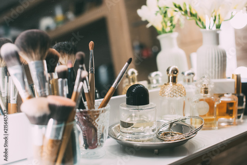 Perfumery and cosmetics on a dressing table with a mirror