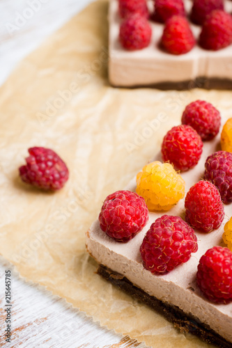 Fresh raspberry cheesecake on the rustic background. Selective focus. Shallow depth of field.