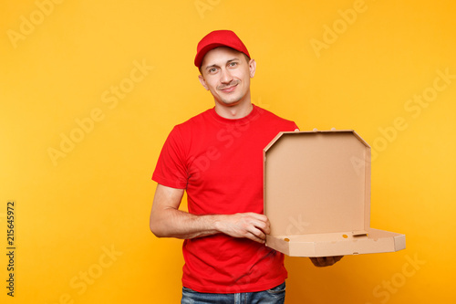 Delivery man in red cap, t-shirt giving food order pizza boxes isolated on yellow background. Male employee pizzaman or courier in uniform holding italian pizza in cardboard flatbox. Service concept.