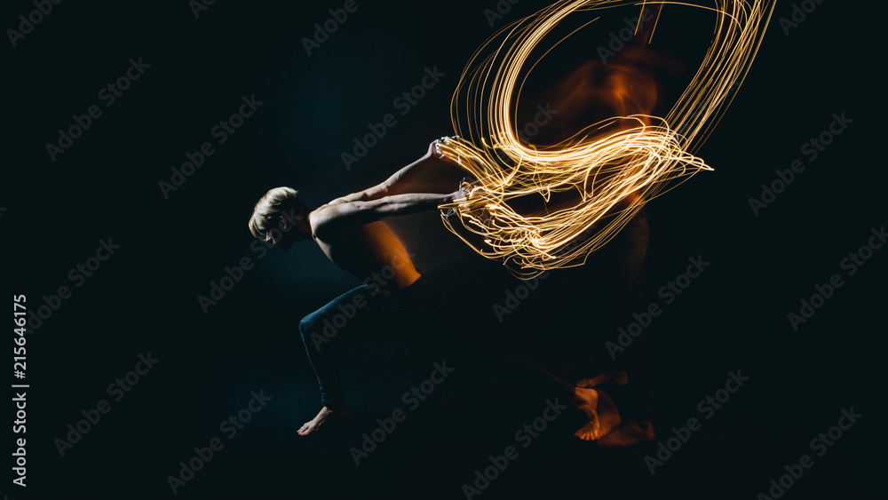 metaphor naked man resistance to battle with problems and depression. Drawing with light. Long exposure creative emotional portrait. Dark background - obrazy, fototapety, plakaty 