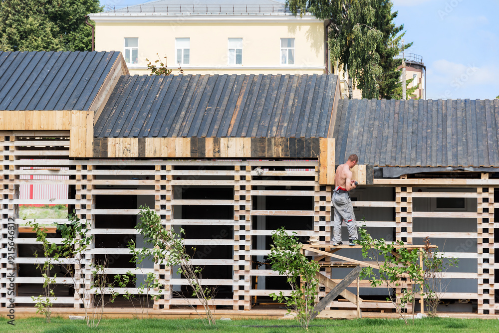 A man is building a wooden house A man is building a wooden house