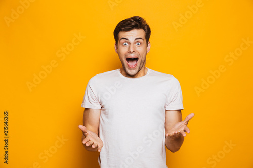 Portrait of an astonished young man celebrating success