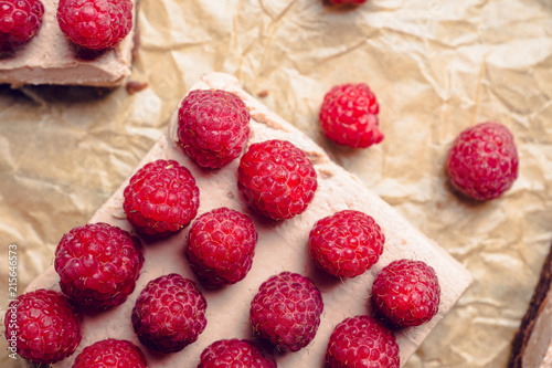 Fresh raspberry cheesecake on the rustic background. Selective focus. Shallow depth of field.