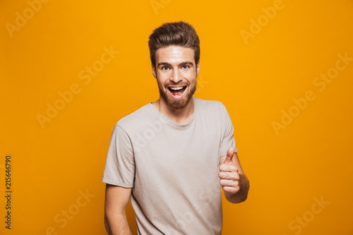 Portrait of a happy young man showing thumbs up