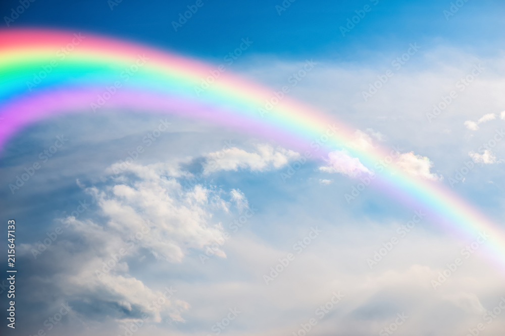 Colorful rainbow in clouds - beauty in nature concept.